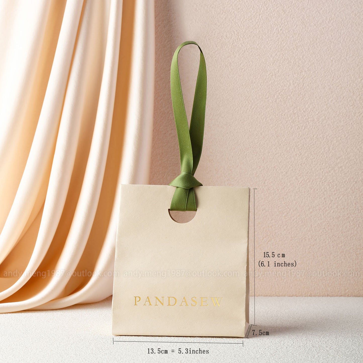 beige paper gift bags with green ribbon