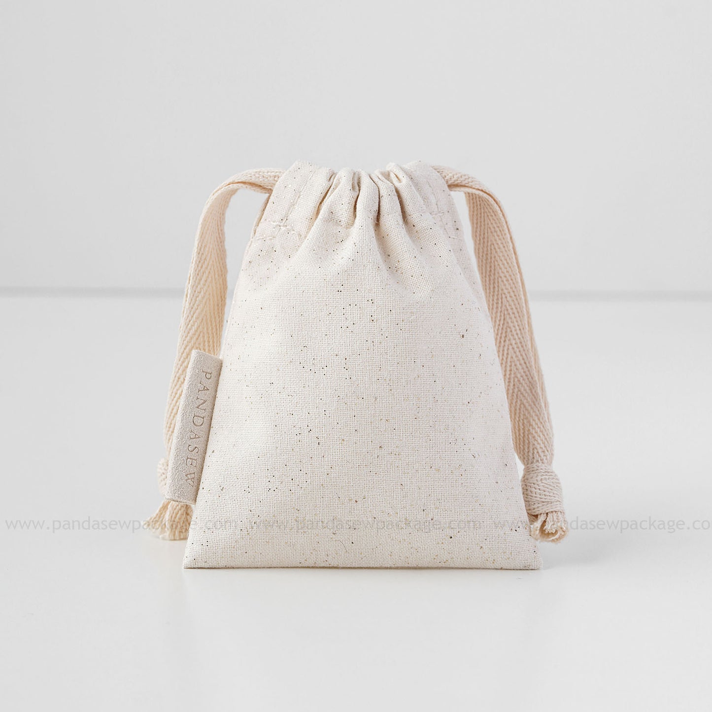 beige cotton drawstring bag with label printing