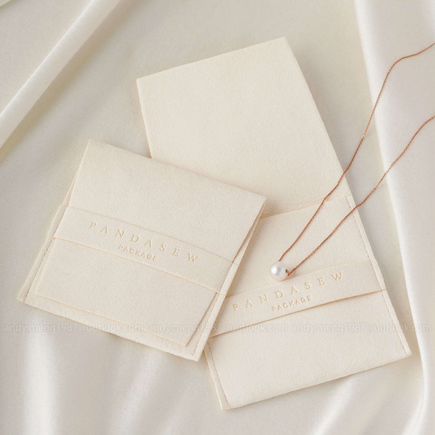 ivory pouch with a necklace beside. The banner can deboss logo, brand name or other text.