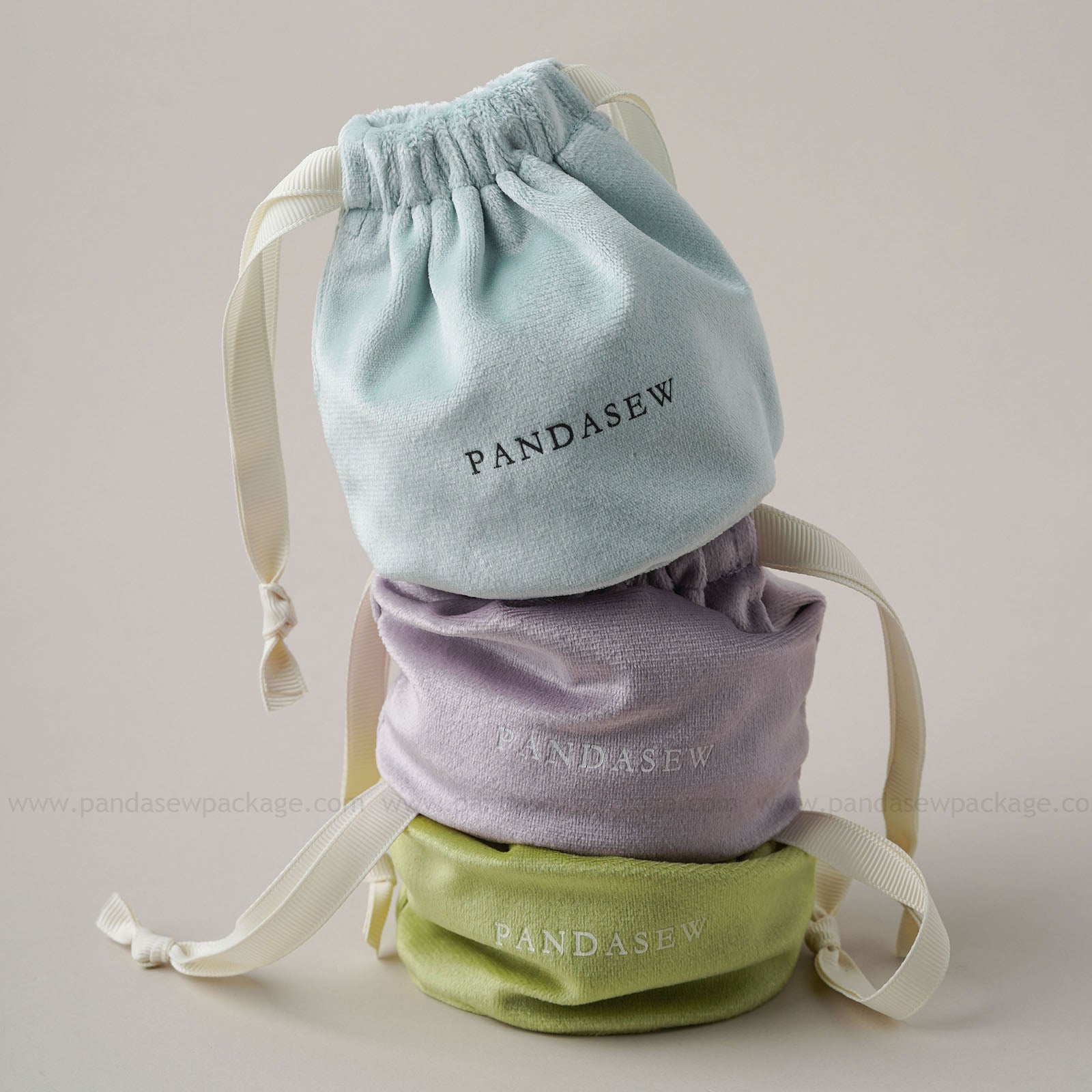 Colorful velvet drawstring pouches: light blue/lavender/green. Custom logo print for aromatherapy packaging