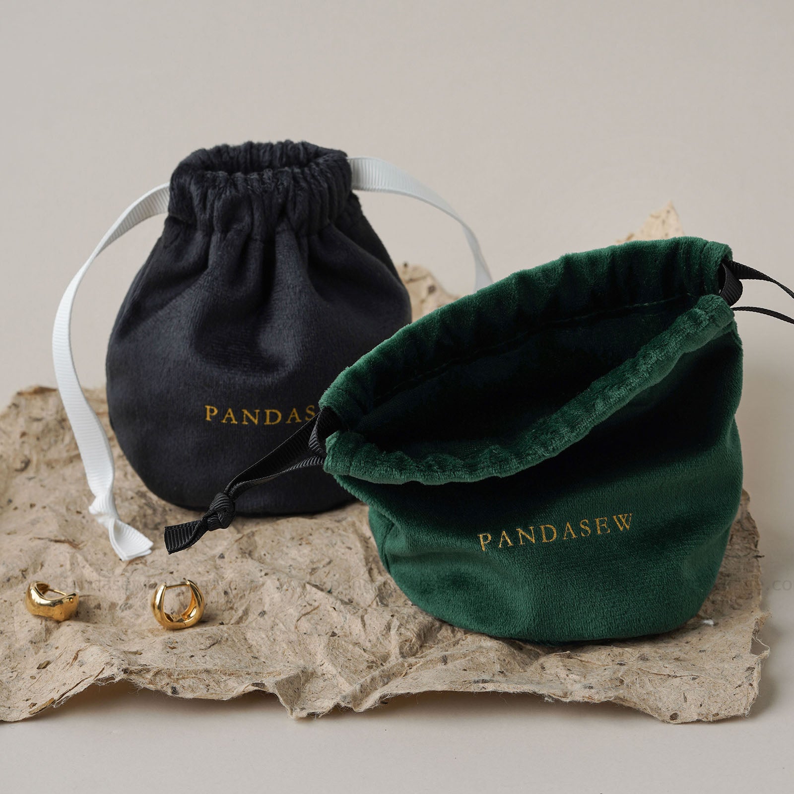 velvet drawstring toiletries bag, black straps. Compact travel storage for cosmetics/toiletries