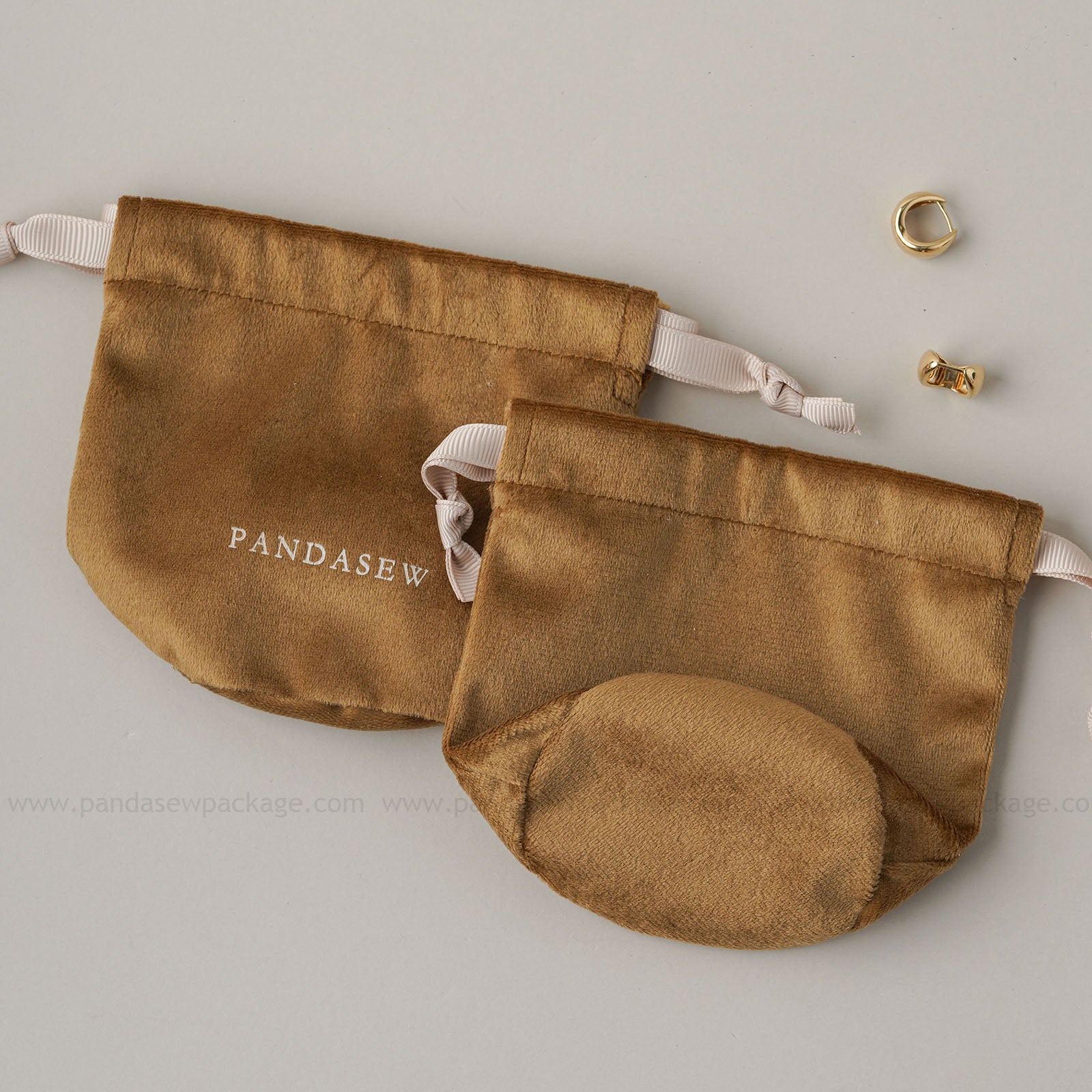 velvet drawstring toiletries bag, black straps. Compact travel storage for cosmetics/toiletries