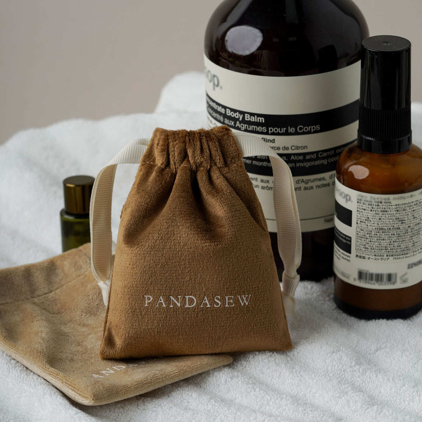 velvet drawstring toiletries bag, black straps. Compact travel storage for cosmetics/toiletries