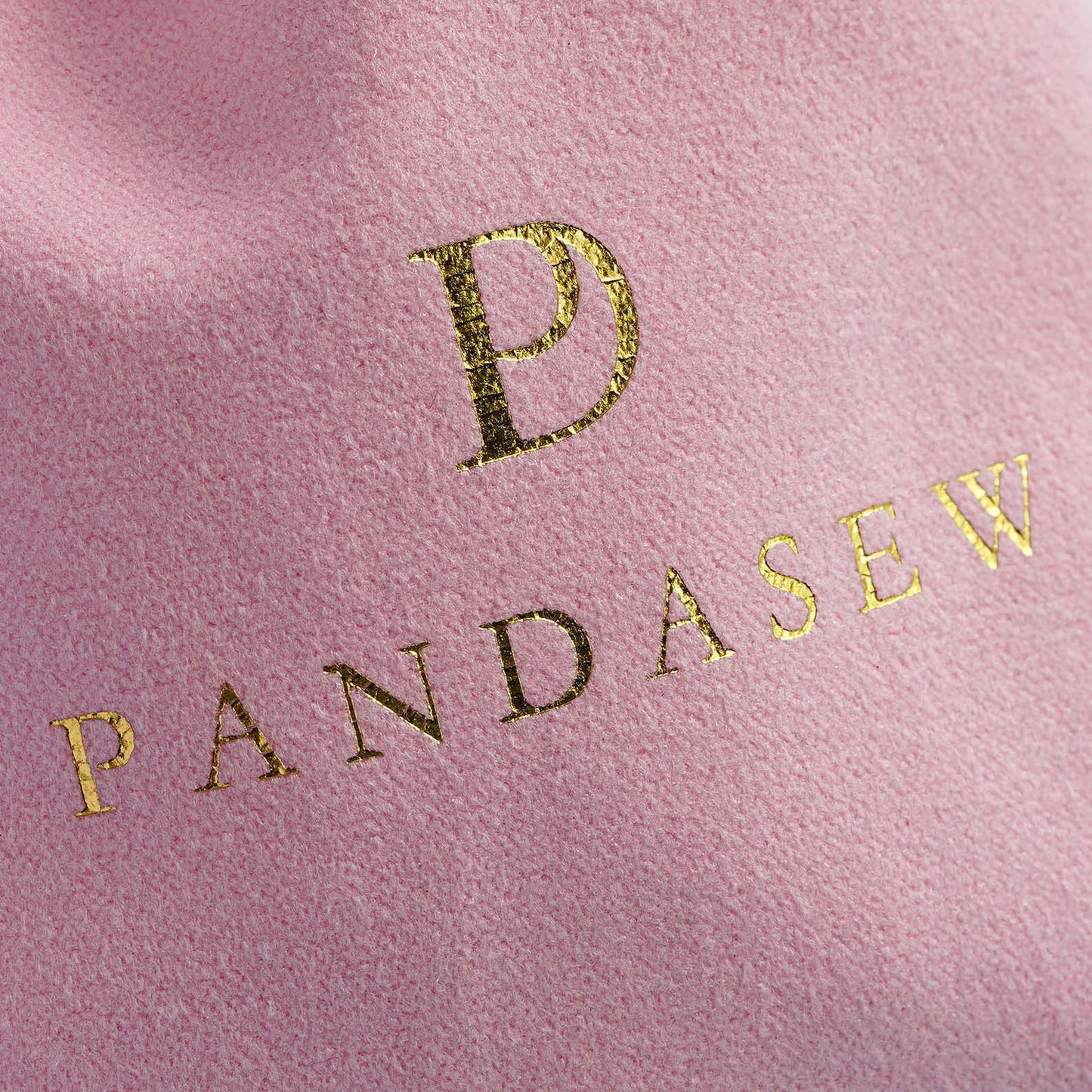 pink velvet pouch with gold foiled logo