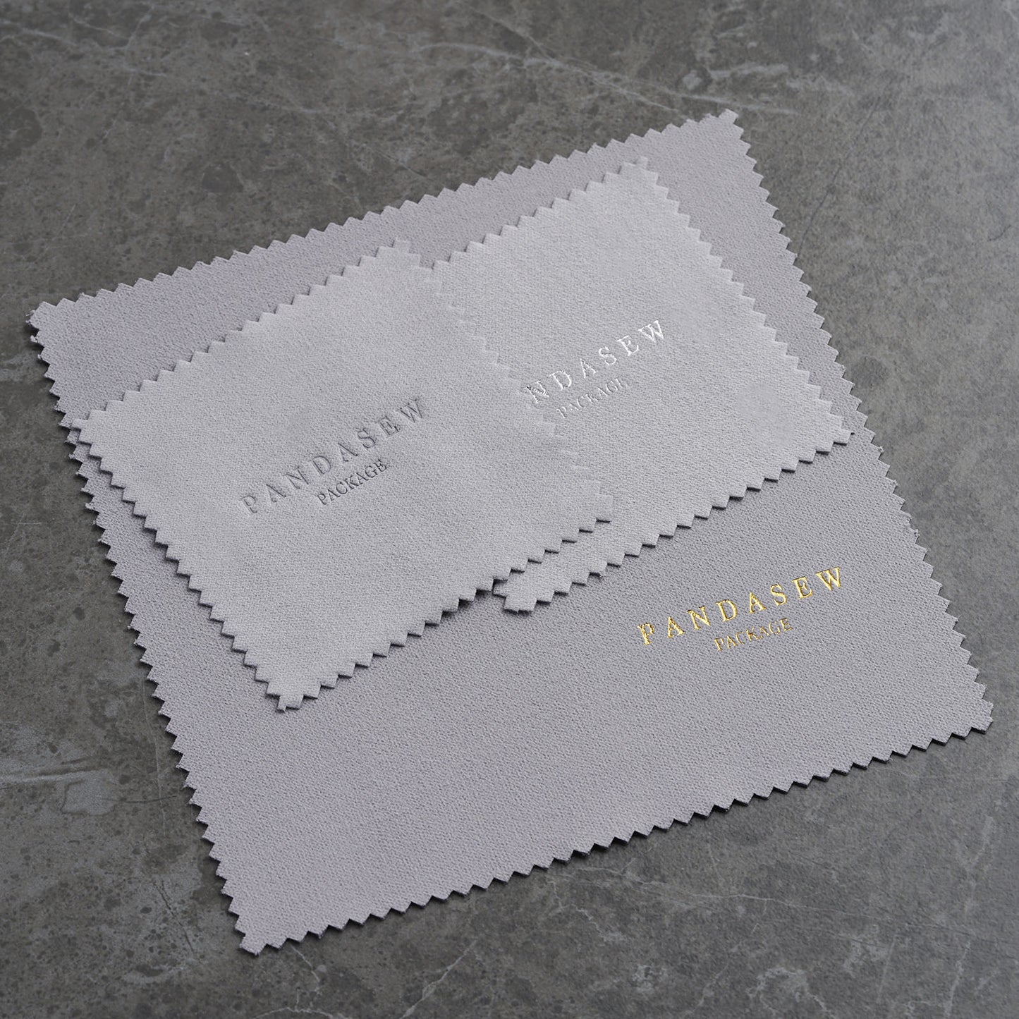 Gray polishing cloth with debossed logo