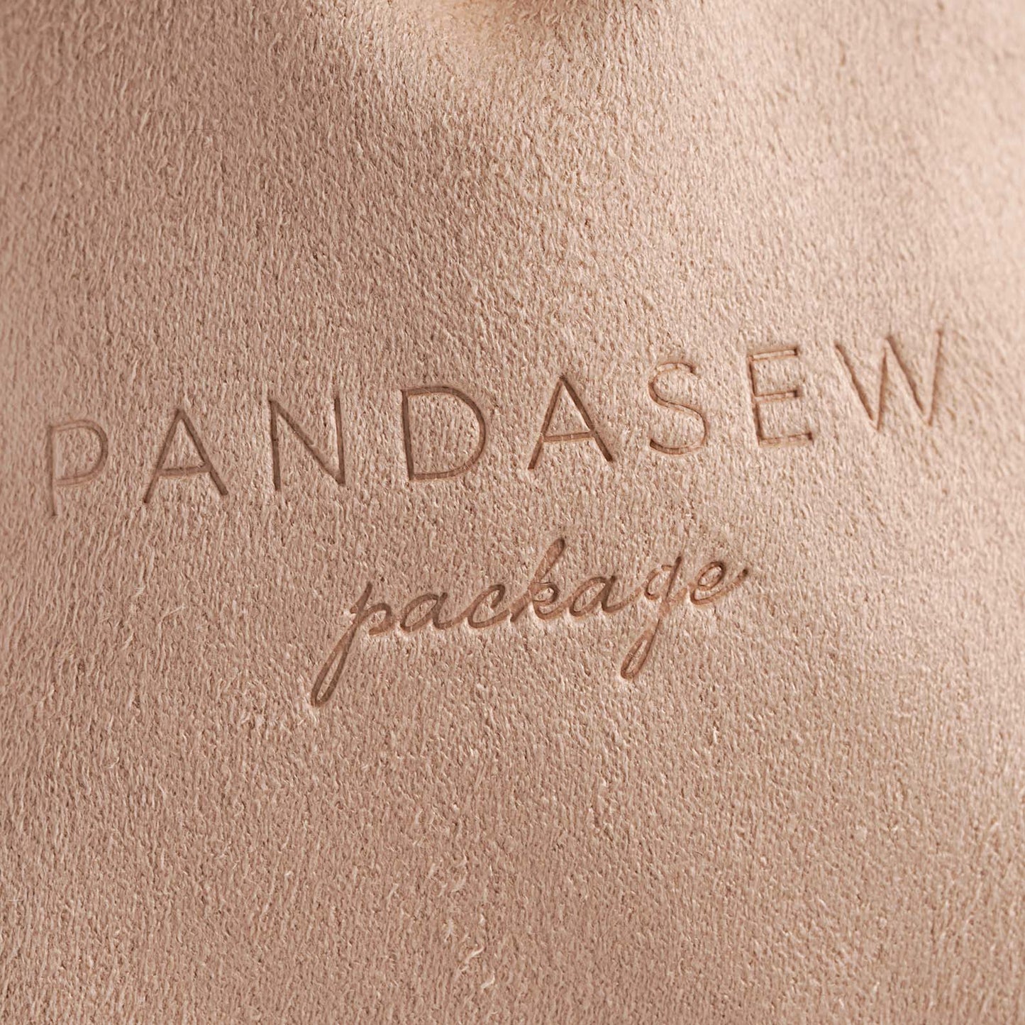 deboss colorless logo on nude velvet bag