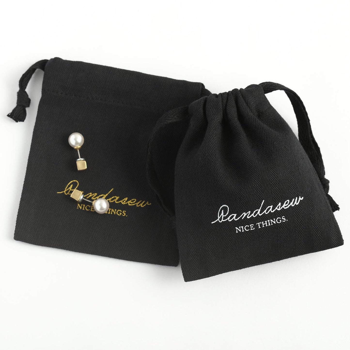 black herringbone twill cotton pouches with white and gold logos