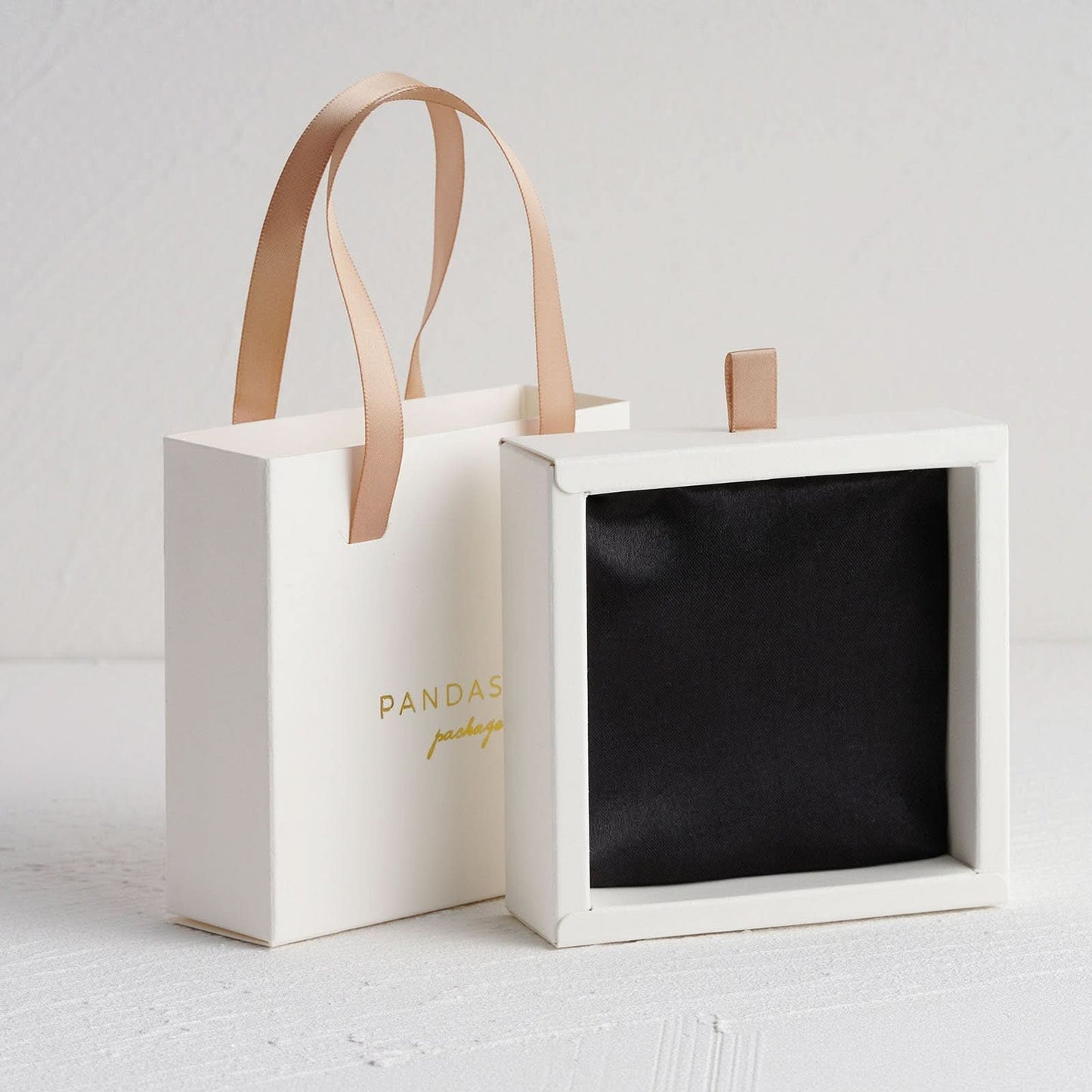 White paper box with champagne ribbon