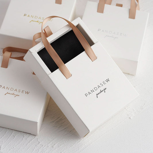 10x10x3.5cm white tote box. there is a well designed sponge inside, which can hold earrings, ring and necklace.