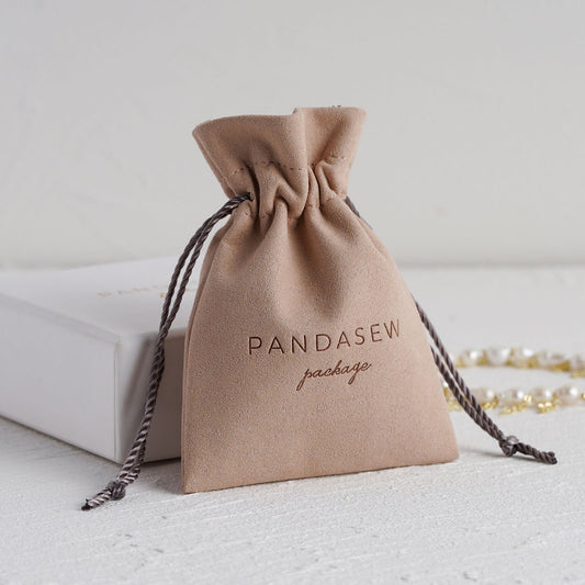 Dark pink drawstring pouch with strongly debossed logo