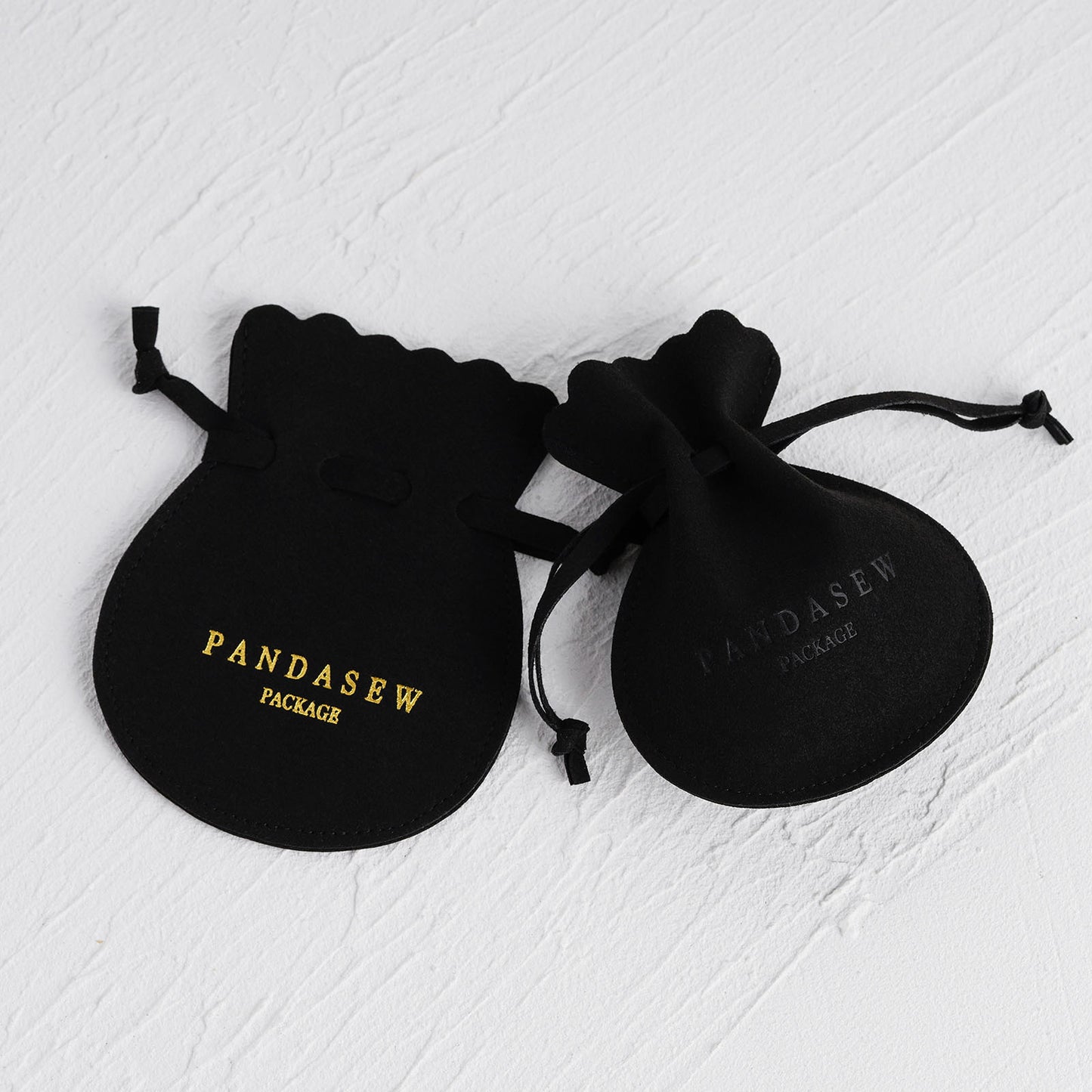 Black jewelry pouch with gold debossed logo