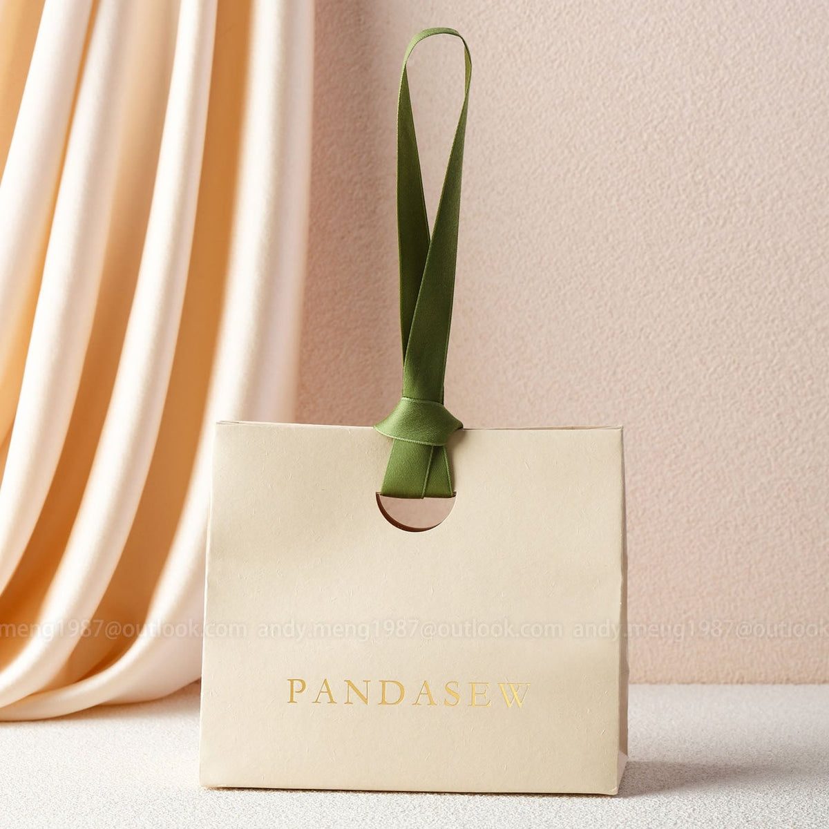 beige paper gift bags with green ribbon