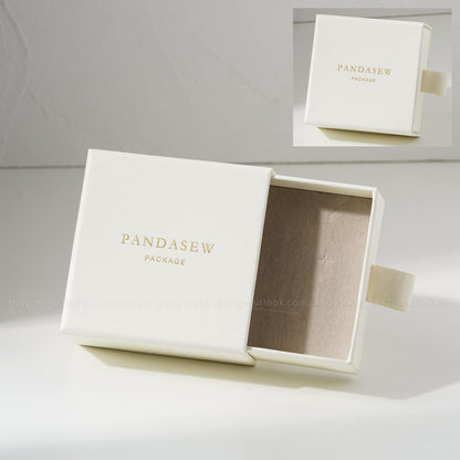 Off-white jewelry box with custom gold logo