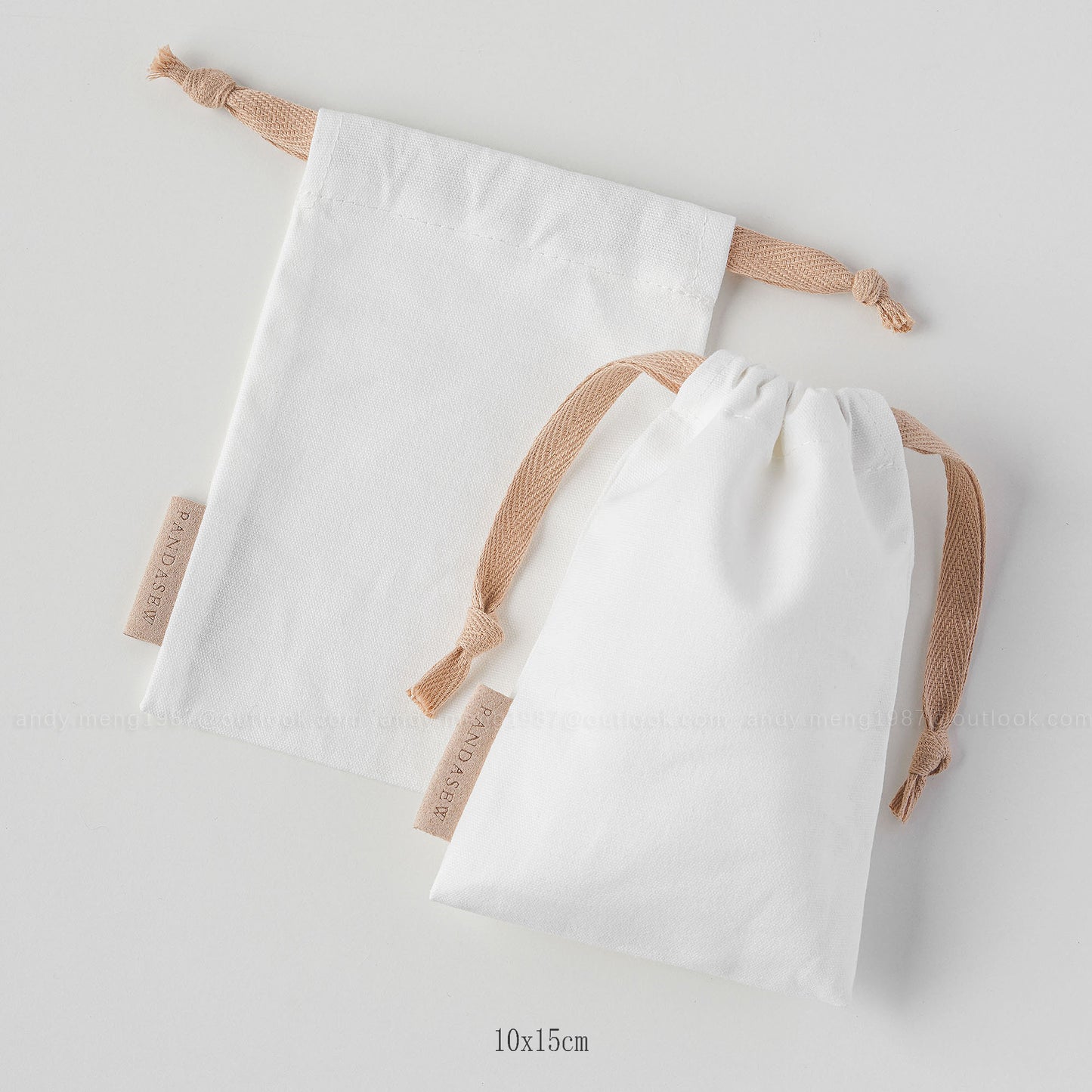 white canvas drawstring bag with label