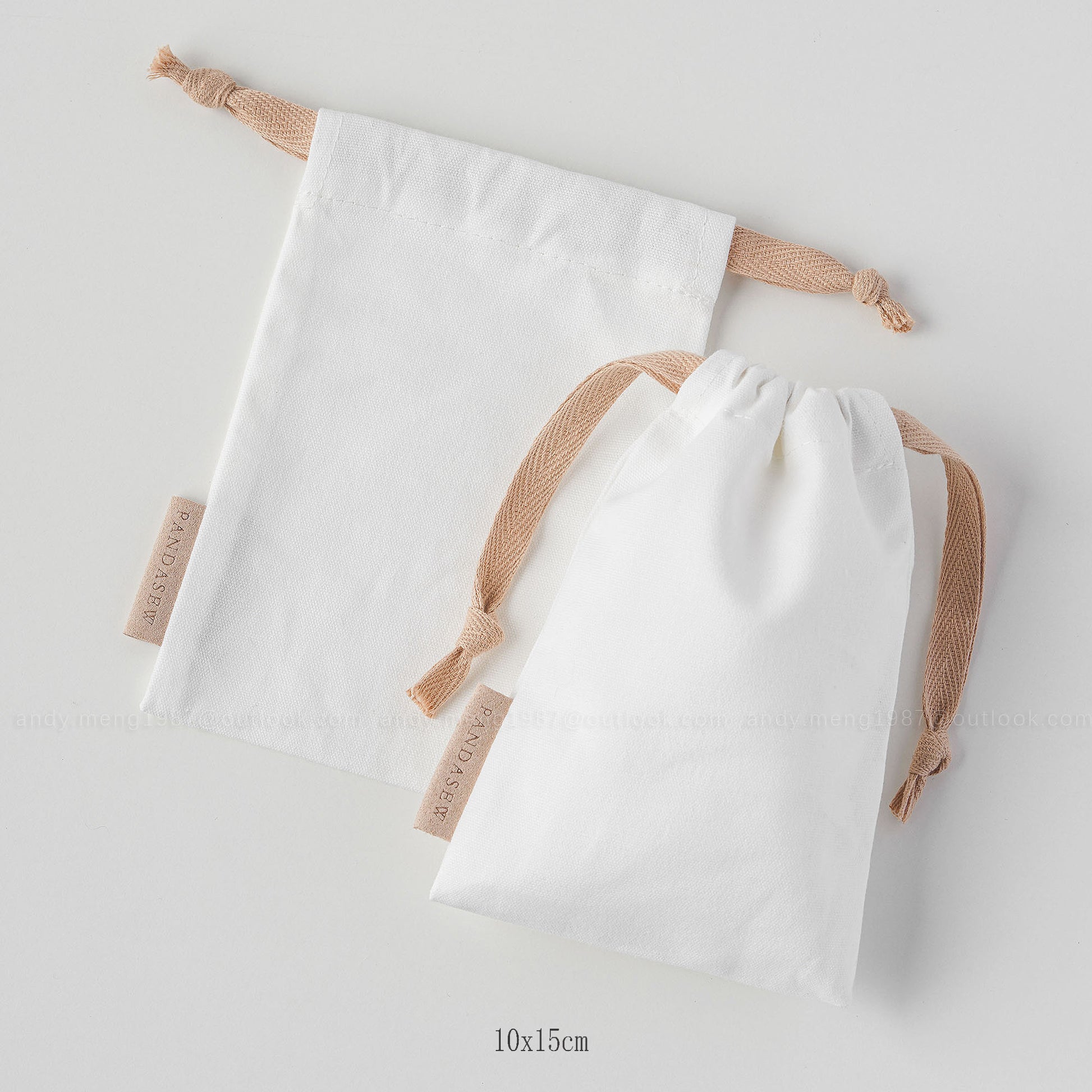 white canvas drawstring bag with label