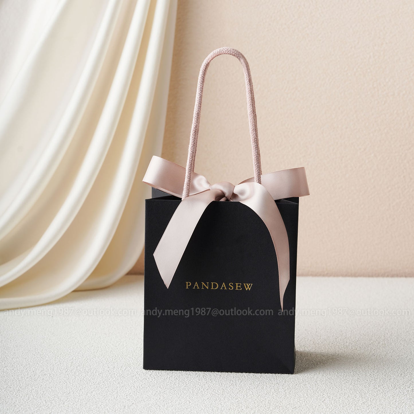 black paper bags with pink handles