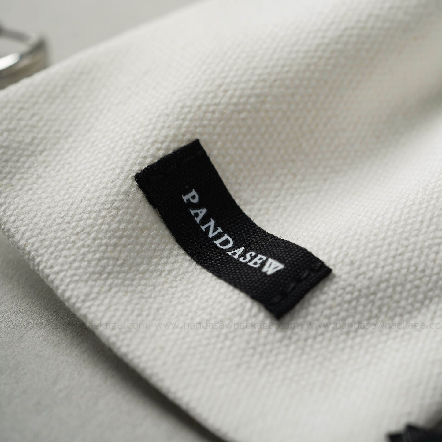 white canvas bag with logo pritn on the label, special jewelry package design