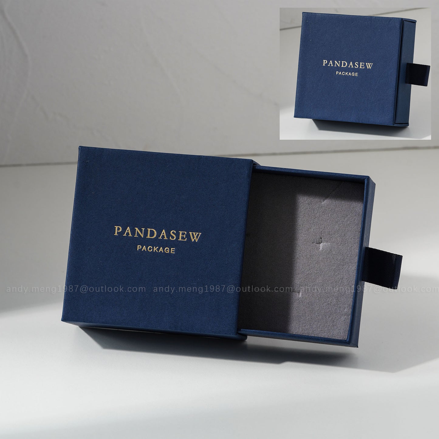 Navy blue jewelry box with custom gold logo