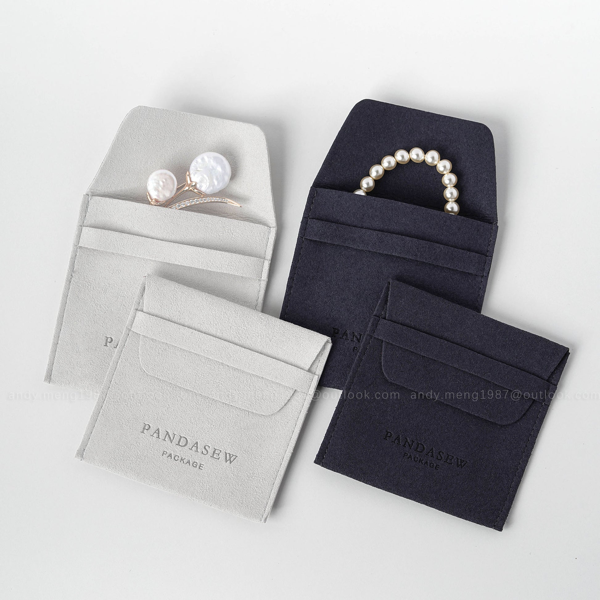 gray and navy jewlery pouch with logo, leather bag