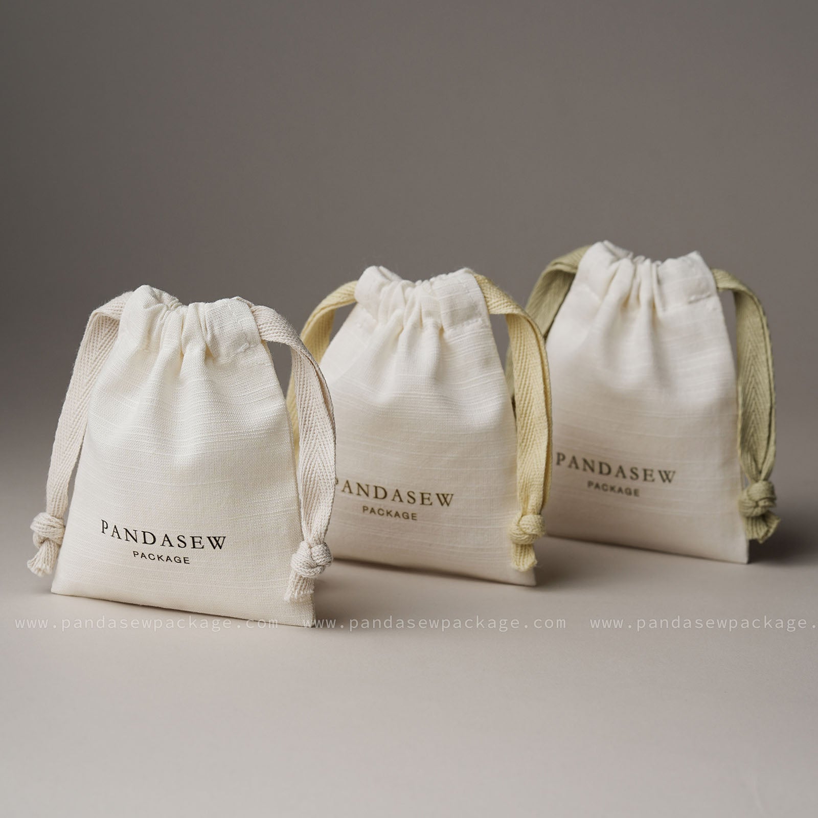 Trio of custom printed cotton bags in varied sizes. Professional branding solutions for handmade businesses