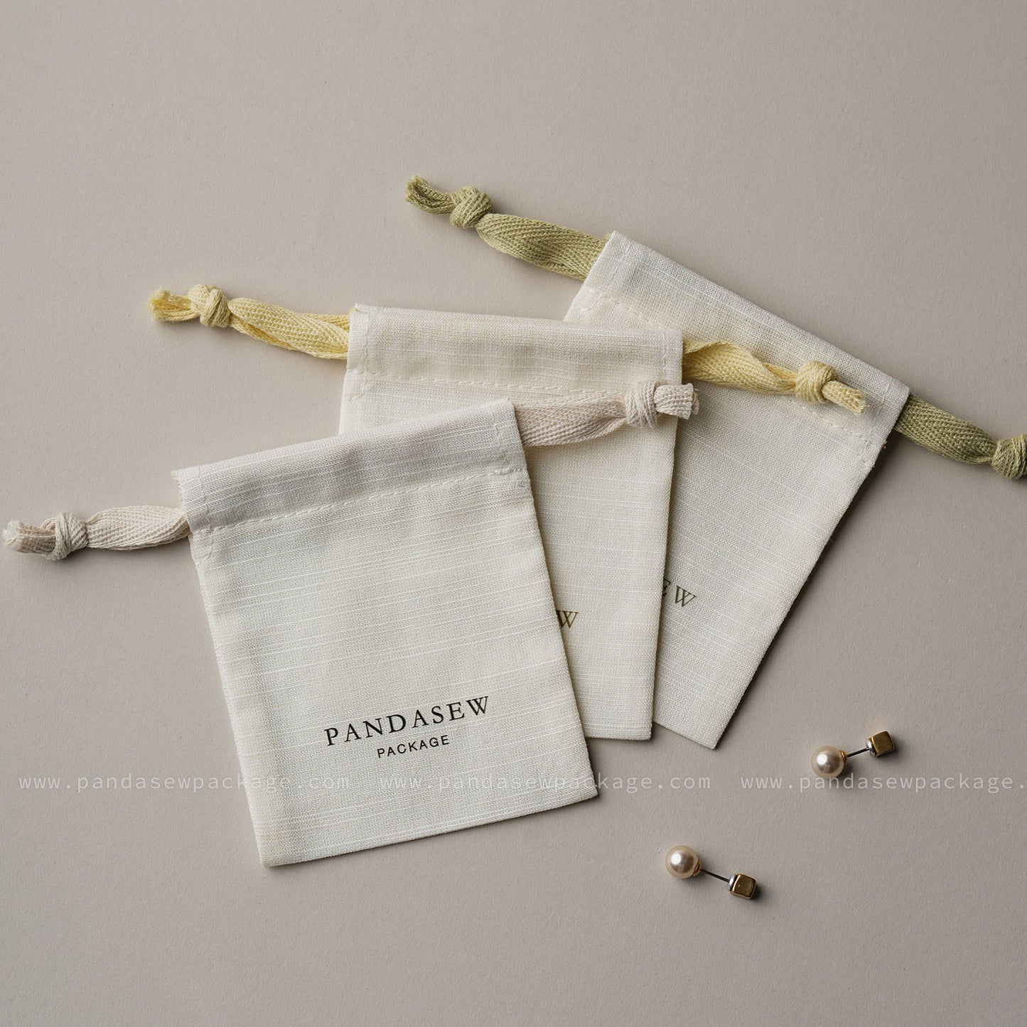 Flat lay of custom jewelry pouches shown with earrings. Personalized packaging size perfect for rings and accessories