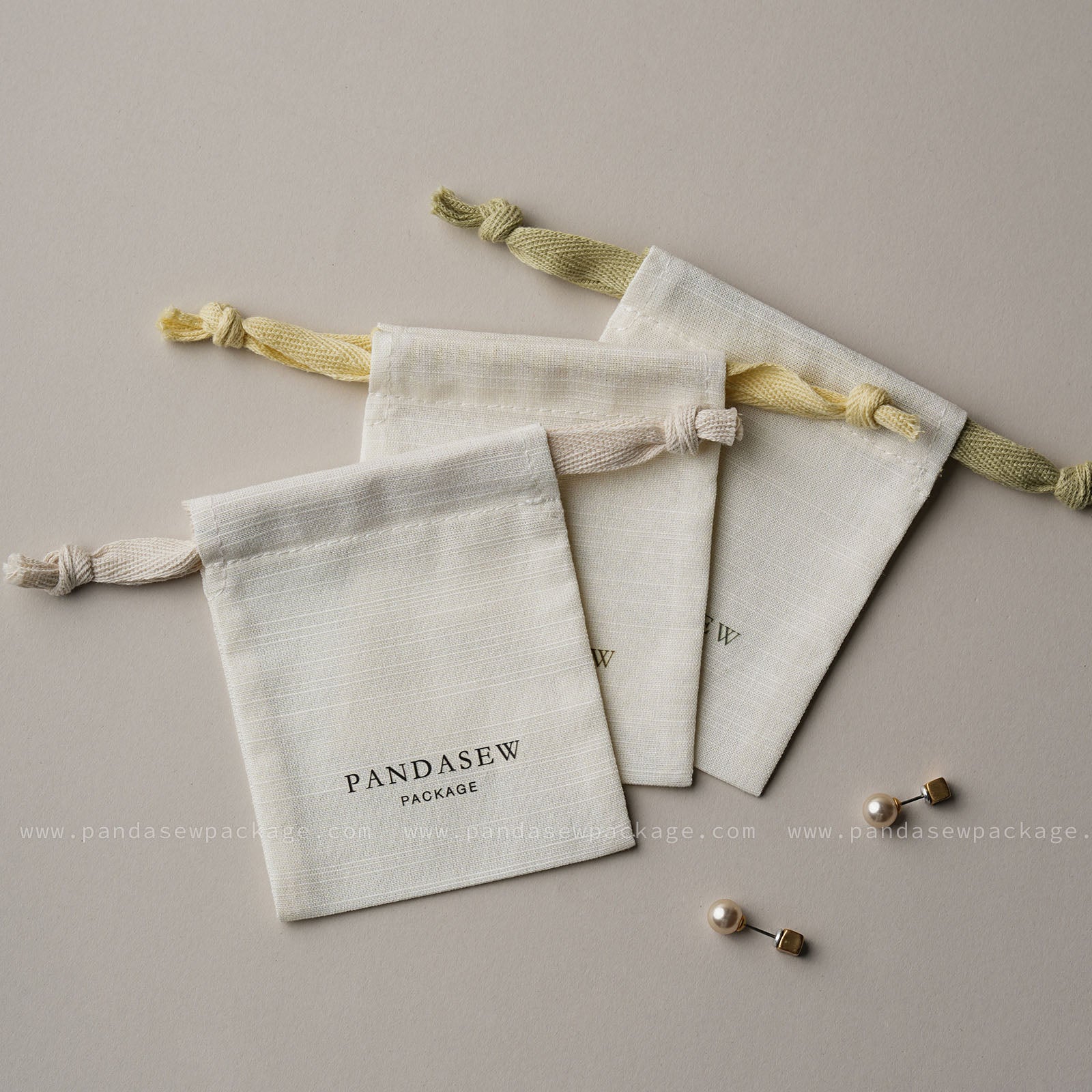 Flat lay of custom jewelry pouches shown with earrings. Personalized packaging size perfect for rings and accessories