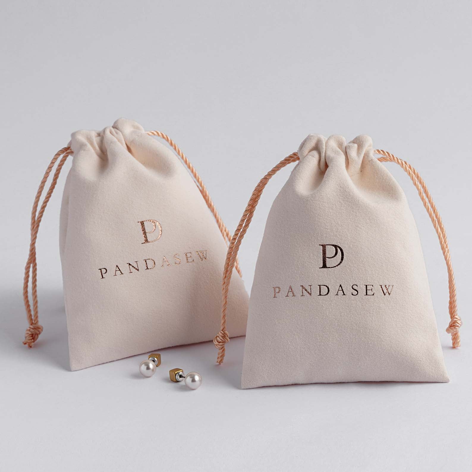 beige velvet bag debossed rose gold logo, custom dust cover