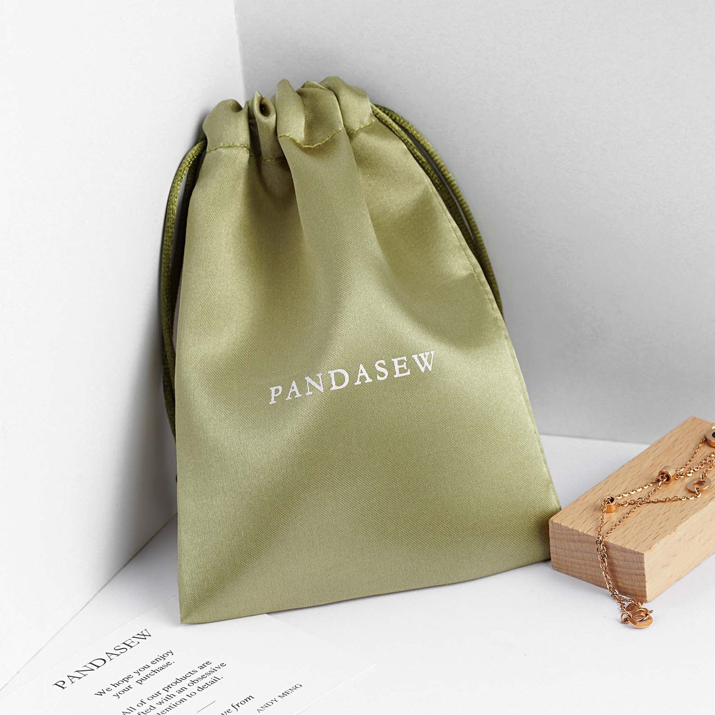 Green satin pouch with custom logo. Cost effective jewelry pouch