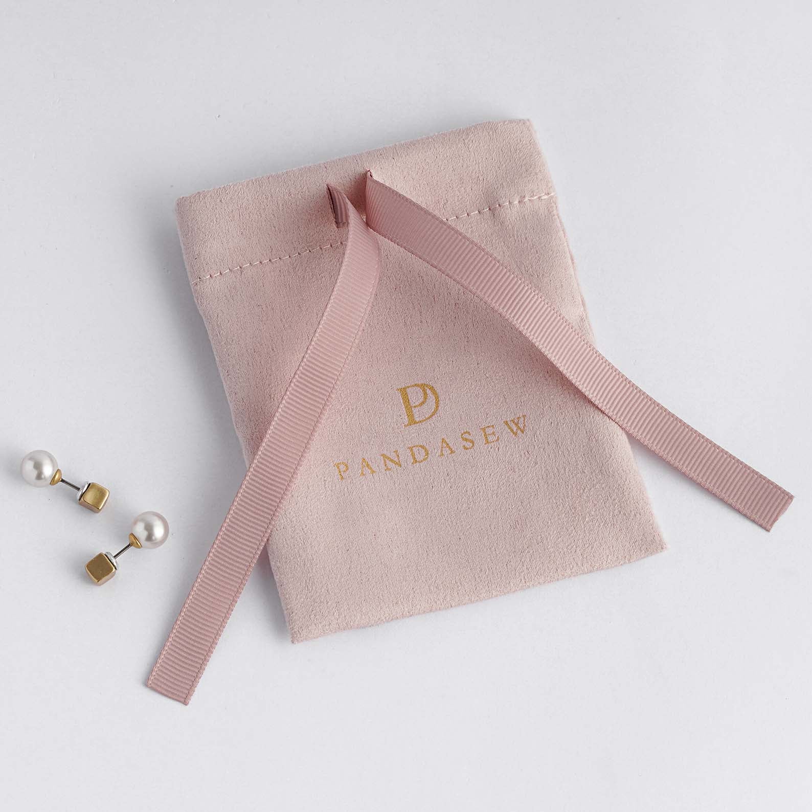 pink flannel bag with pink grosgrain ribbon tied in the middle, jewelry pouch