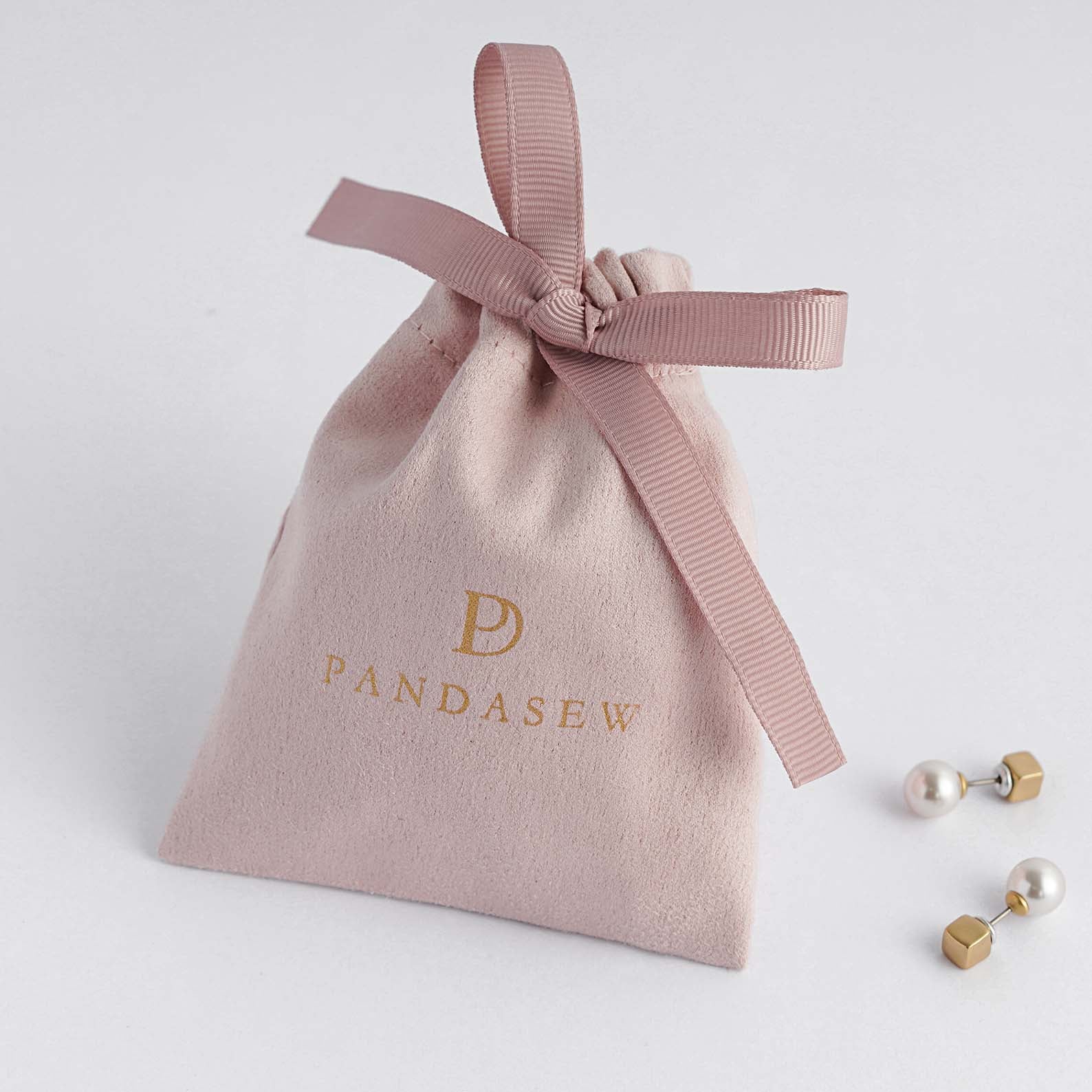pink flannel bag with pink grosgrain ribbon tied in the middle, jewelry pouch